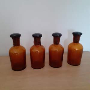A Set of Four Vintage Amber Glass Pharmacy Bottles