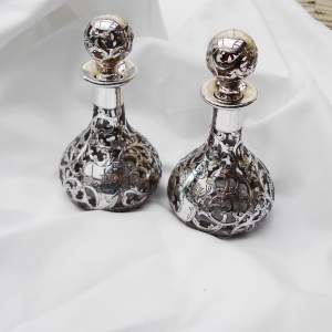 A Pair of Silver Overlaid Perfume Bottles