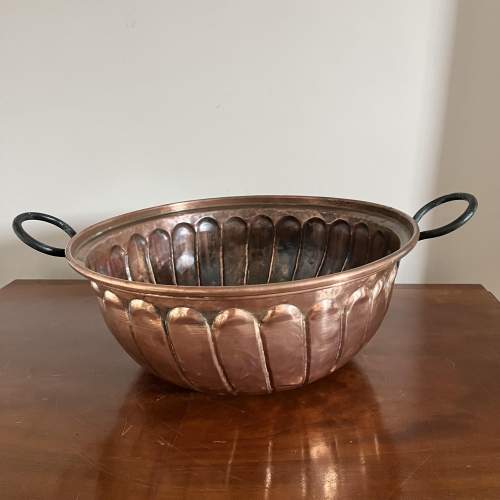 A Large Repousse Copper Bowl with Iron Handles image-1