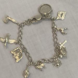 Delightful Silver Charm Bracelet with Ten Charms and a 3d bit