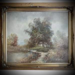 A Gilt Framed Oil on Canvas depicting a Cottage by a Lake