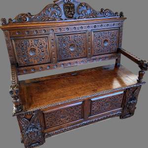 A Victorian Carved oak Settle.