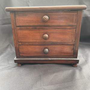 A Miniature Chest Of Drawers