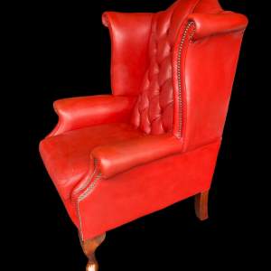 A Buttoned Red Leather Chesterfield Wing Armchair