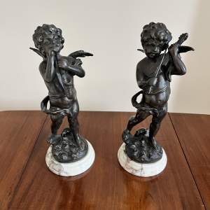 A Pair of Bronzed Cast Metal Cherubs on Marble Bases