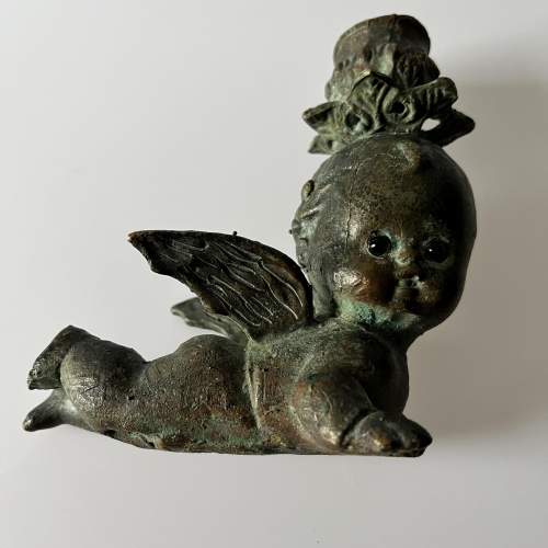 A Pair of Bronze Cherub Candlesticks with Green Glass Eyes image-4